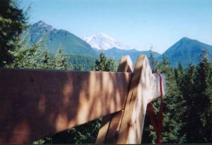View of Mt. Rainier and nearby peaks from the loft area at 100 feet above the ground.  (Wooden beam for hoisting operation is in foreground.)